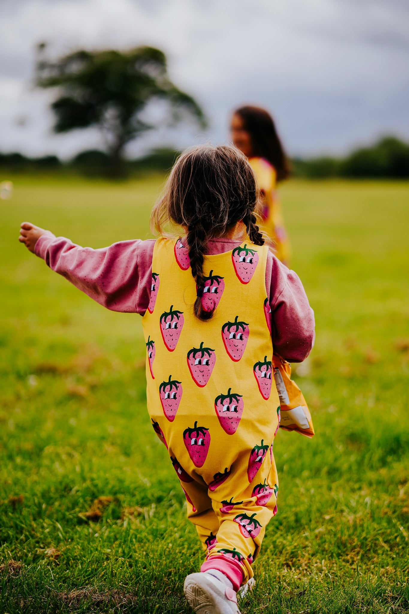 Handmade baby and toddler jersey romper in yellow and pink fun character strawberry print