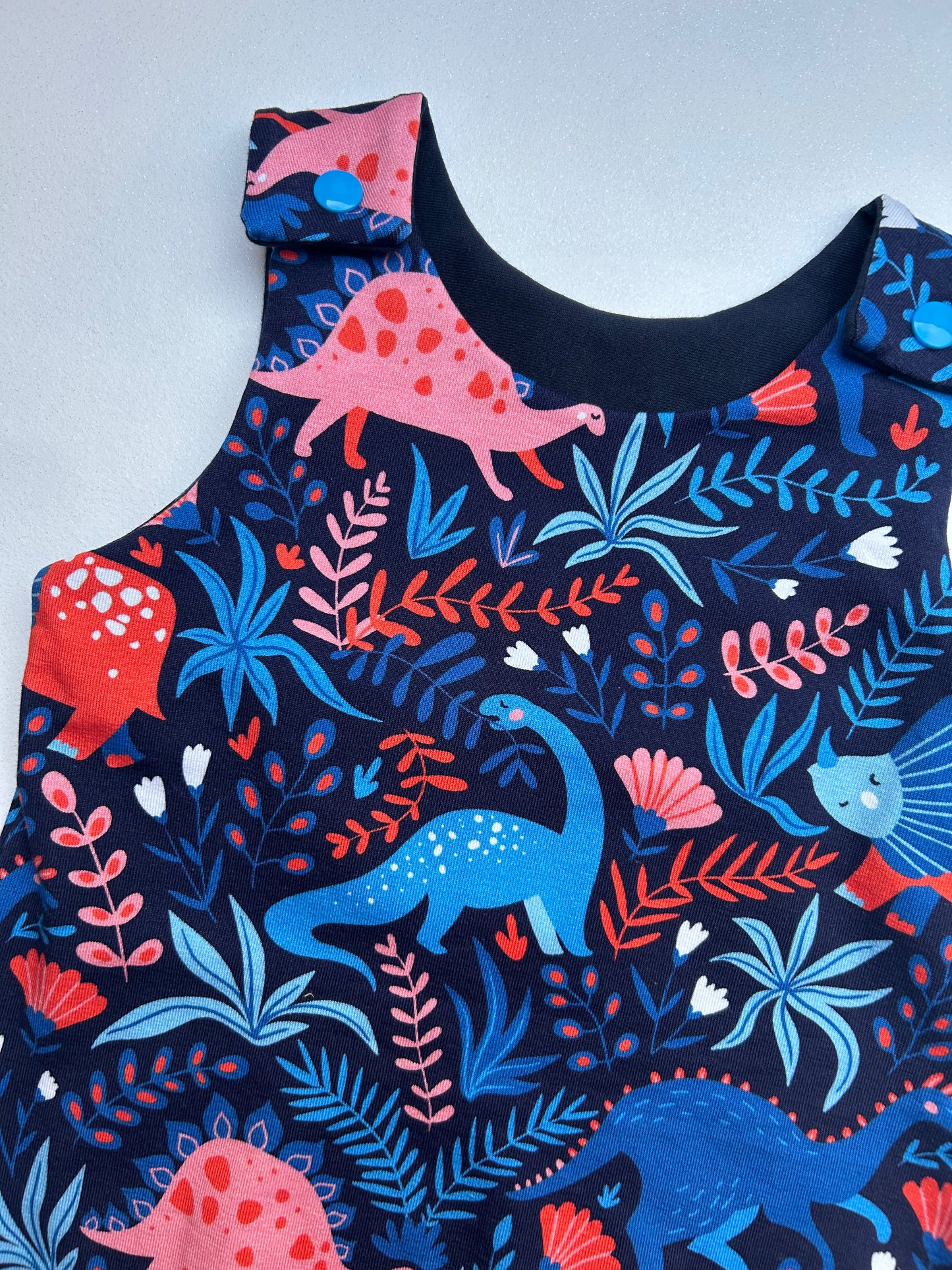 Super soft dinosaur print jersey romper. Handmade in Sheffield